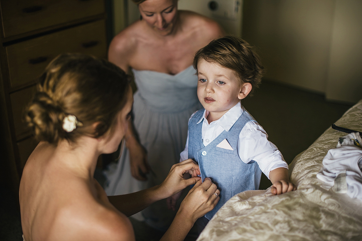 Suzy wore a stunning ombre/dip dye dress for her barefoot beach wedding in New Zealand. Photography by Meredith Lord.