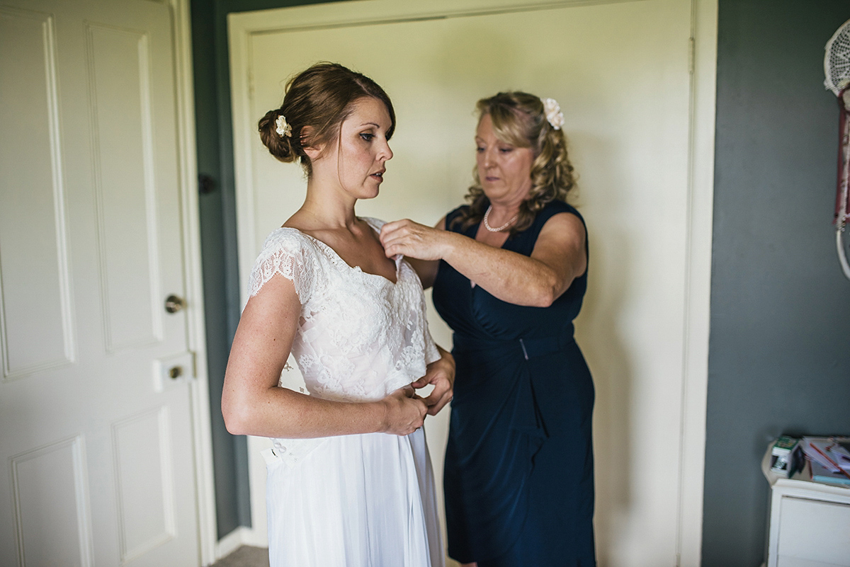 Suzy wore a stunning ombre/dip dye dress for her barefoot beach wedding in New Zealand. Photography by Meredith Lord.