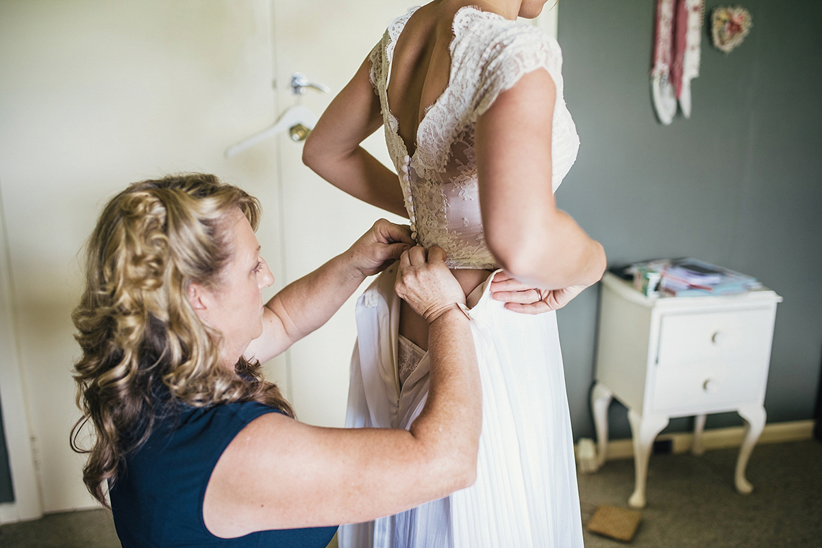 Suzy wore a stunning ombre/dip dye dress for her barefoot beach wedding in New Zealand. Photography by Meredith Lord.