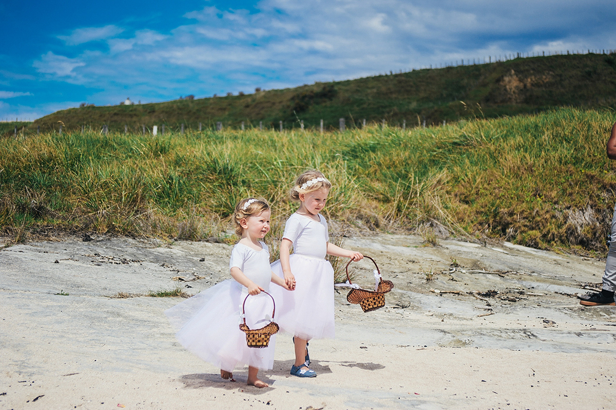 Suzy wore a stunning ombre/dip dye dress for her barefoot beach wedding in New Zealand. Photography by Meredith Lord.