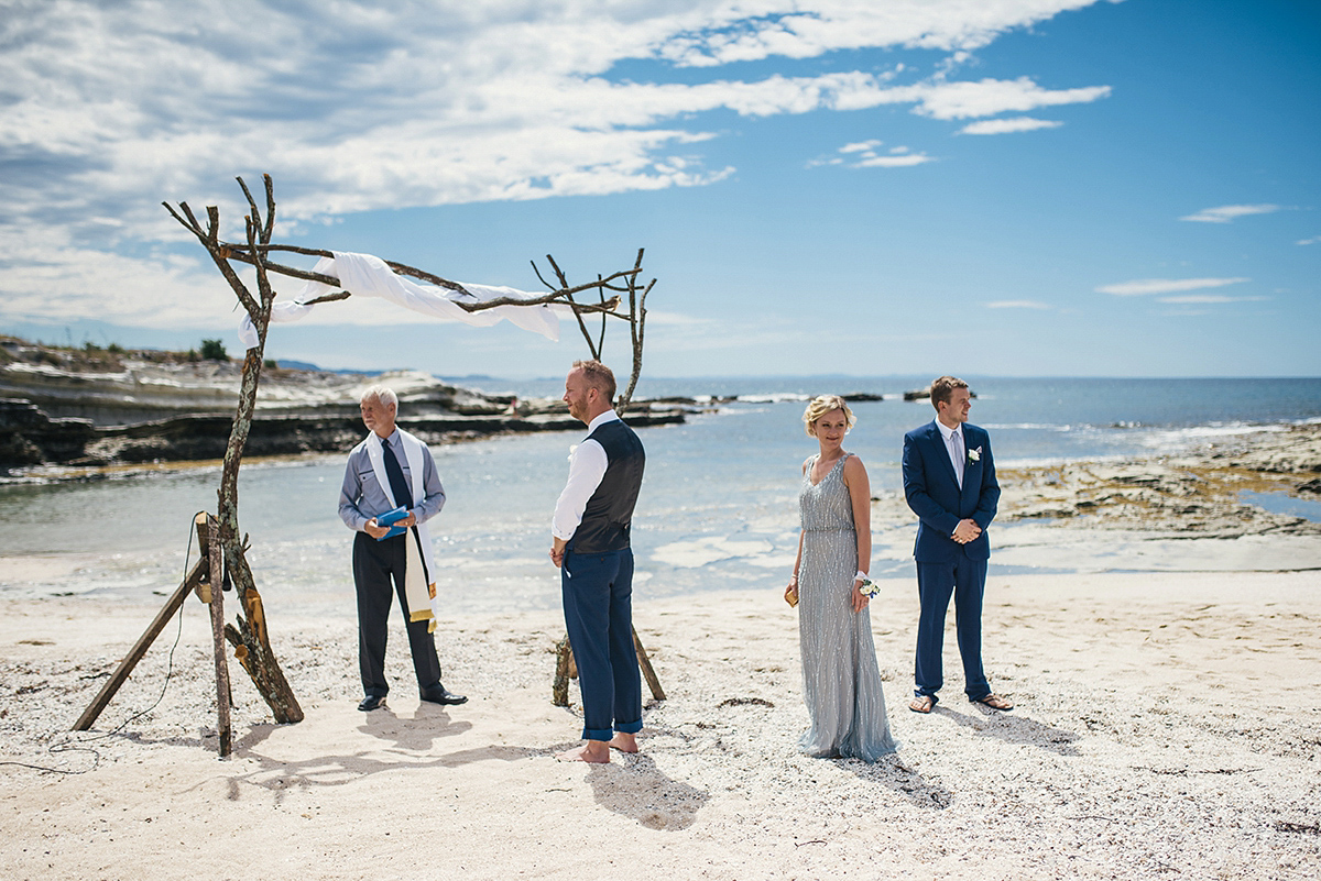 Suzy wore a stunning ombre/dip dye dress for her barefoot beach wedding in New Zealand. Photography by Meredith Lord.