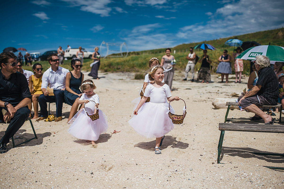 Suzy wore a stunning ombre/dip dye dress for her barefoot beach wedding in New Zealand. Photography by Meredith Lord.