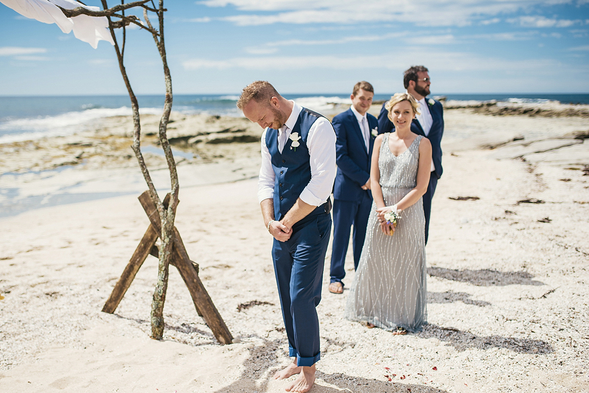 Suzy wore a stunning ombre/dip dye dress for her barefoot beach wedding in New Zealand. Photography by Meredith Lord.