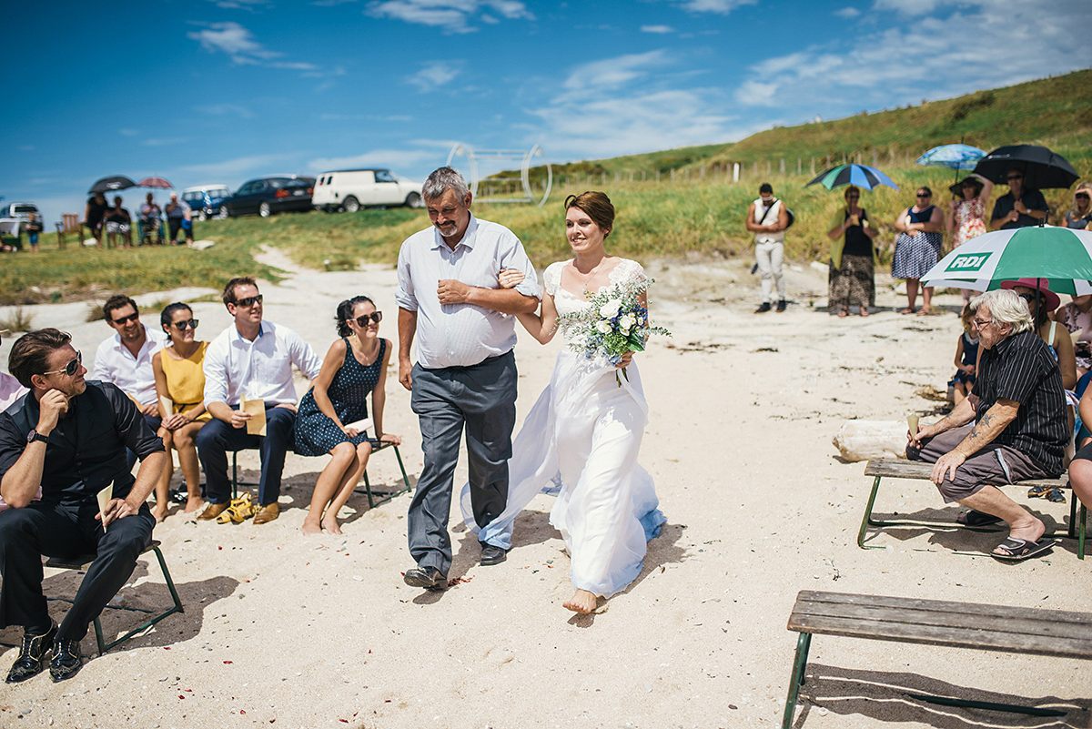 Suzy wore a stunning ombre/dip dye dress for her barefoot beach wedding in New Zealand. Photography by Meredith Lord.