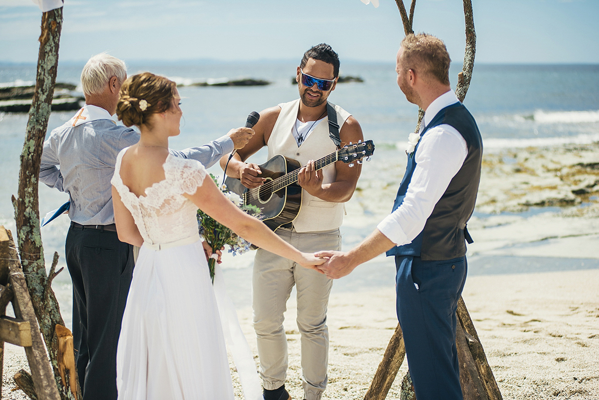 Suzy wore a stunning ombre/dip dye dress for her barefoot beach wedding in New Zealand. Photography by Meredith Lord.