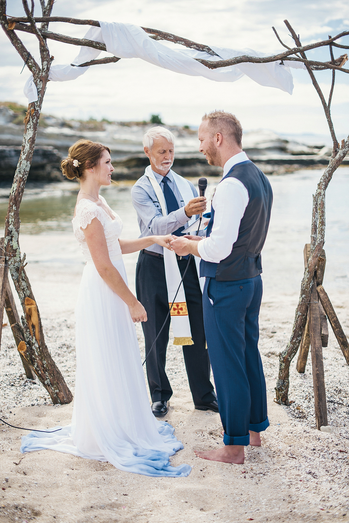 Suzy wore a stunning ombre/dip dye dress for her barefoot beach wedding in New Zealand. Photography by Meredith Lord.