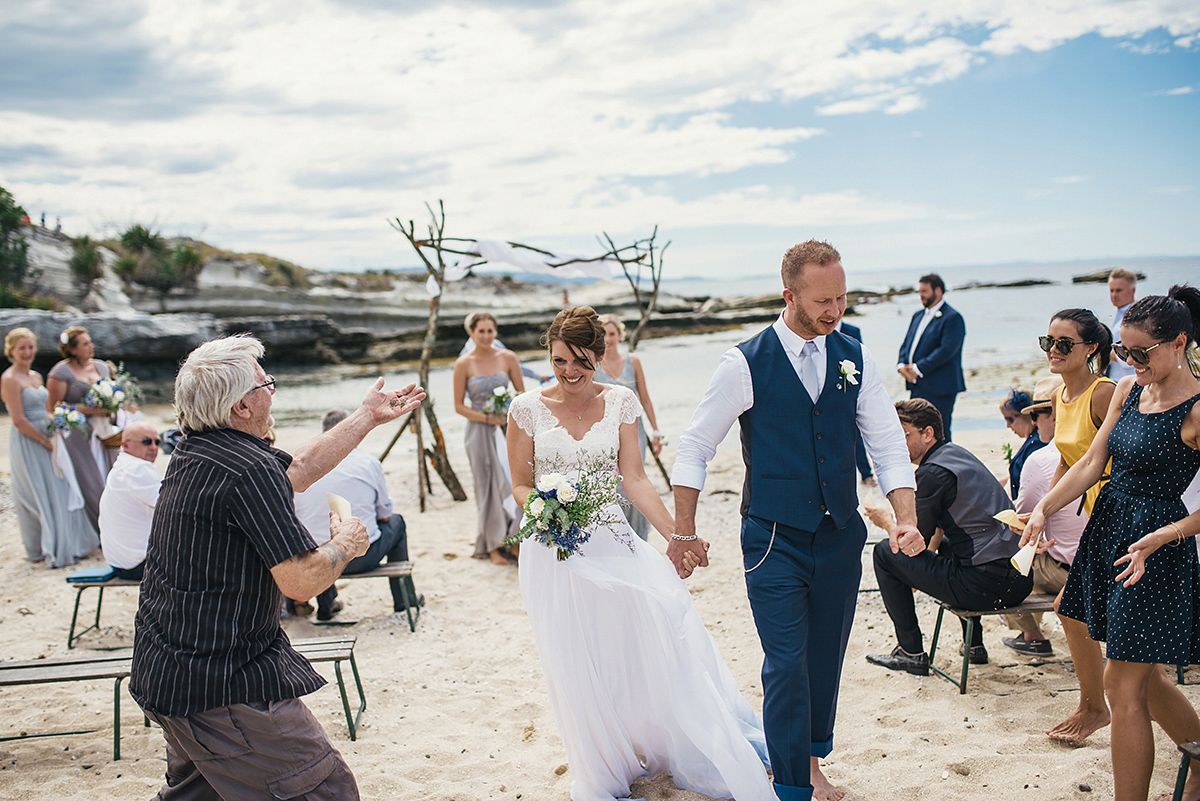 Suzy wore a stunning ombre/dip dye dress for her barefoot beach wedding in New Zealand. Photography by Meredith Lord.