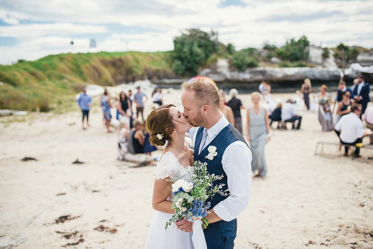 Suzy wore a stunning ombre/dip dye dress for her barefoot beach wedding in New Zealand. Photography by Meredith Lord.