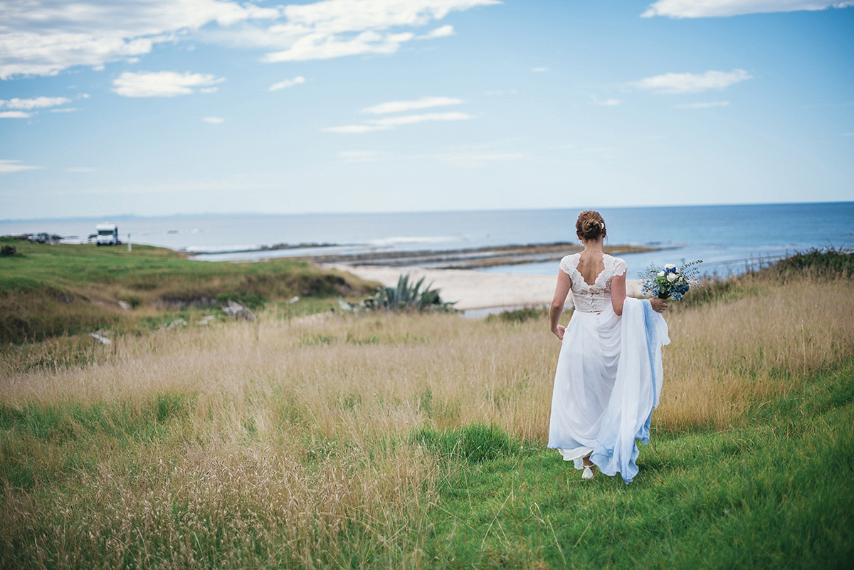 Suzy wore a stunning ombre/dip dye dress for her barefoot beach wedding in New Zealand. Photography by Meredith Lord.