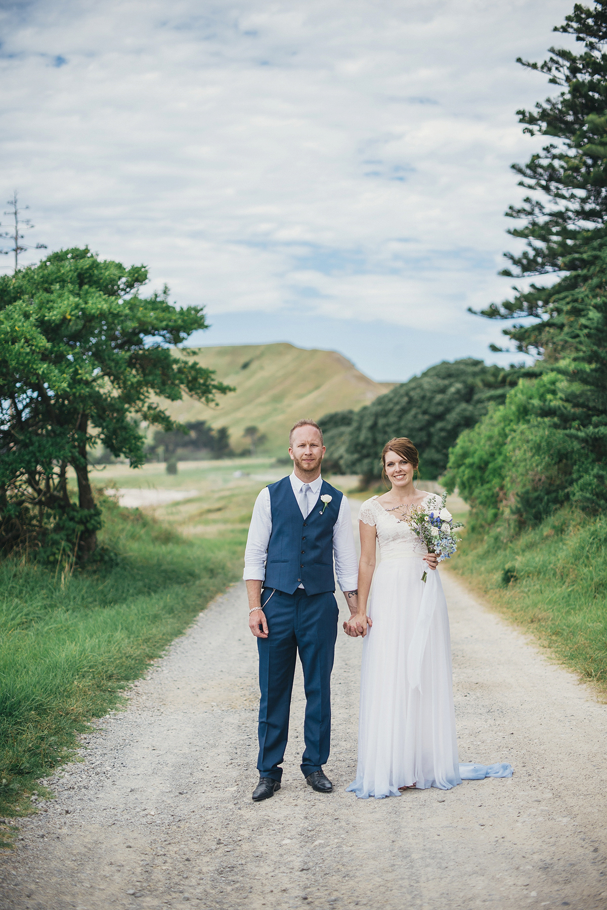 Suzy wore a stunning ombre/dip dye dress for her barefoot beach wedding in New Zealand. Photography by Meredith Lord.