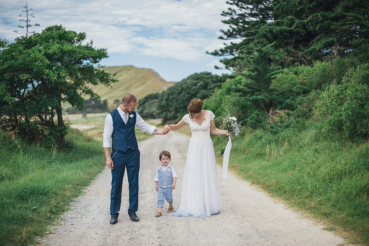 Suzy wore a stunning ombre/dip dye dress for her barefoot beach wedding in New Zealand. Photography by Meredith Lord.