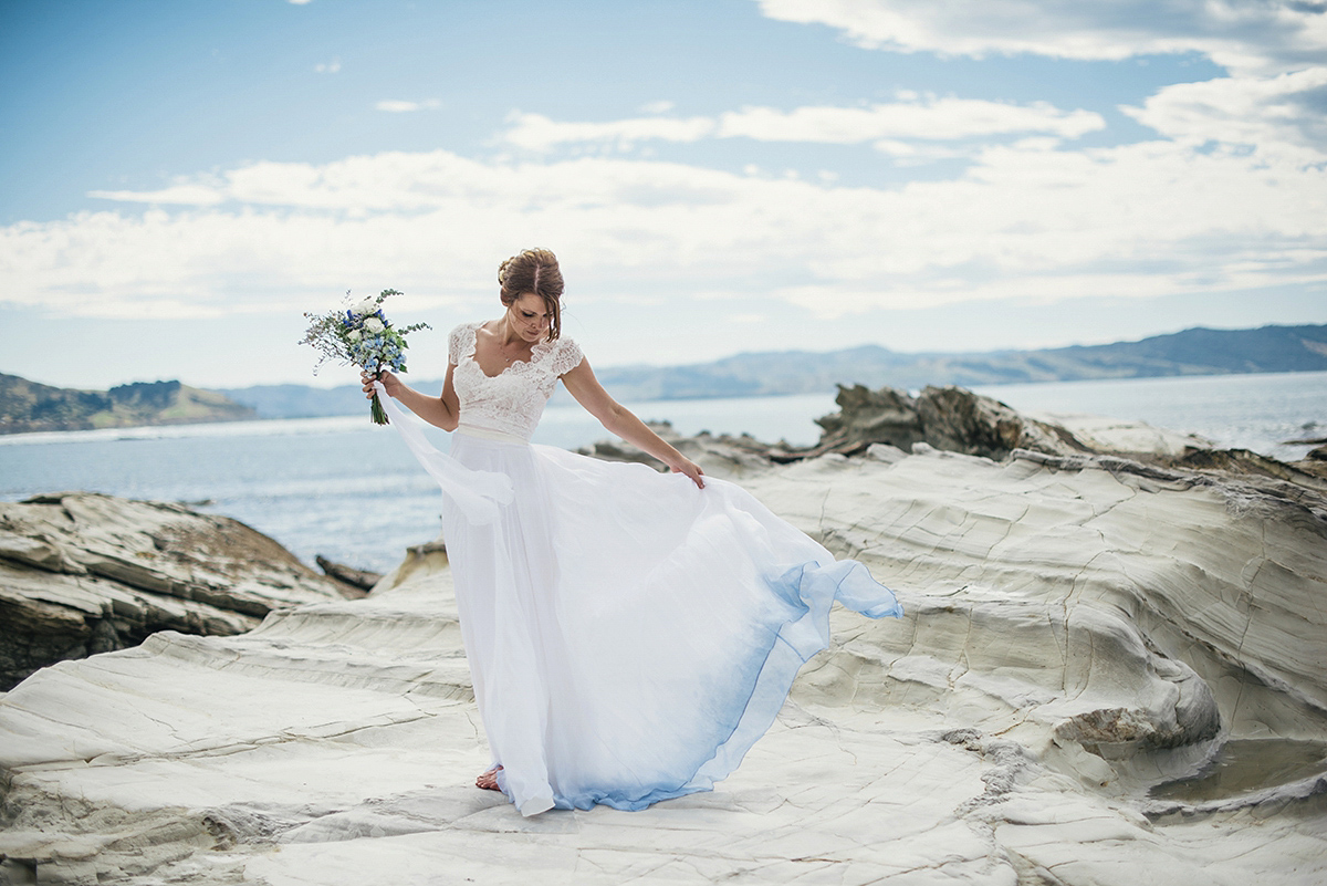 Suzy wore a stunning ombre/dip dye dress for her barefoot beach wedding in New Zealand. Photography by Meredith Lord.