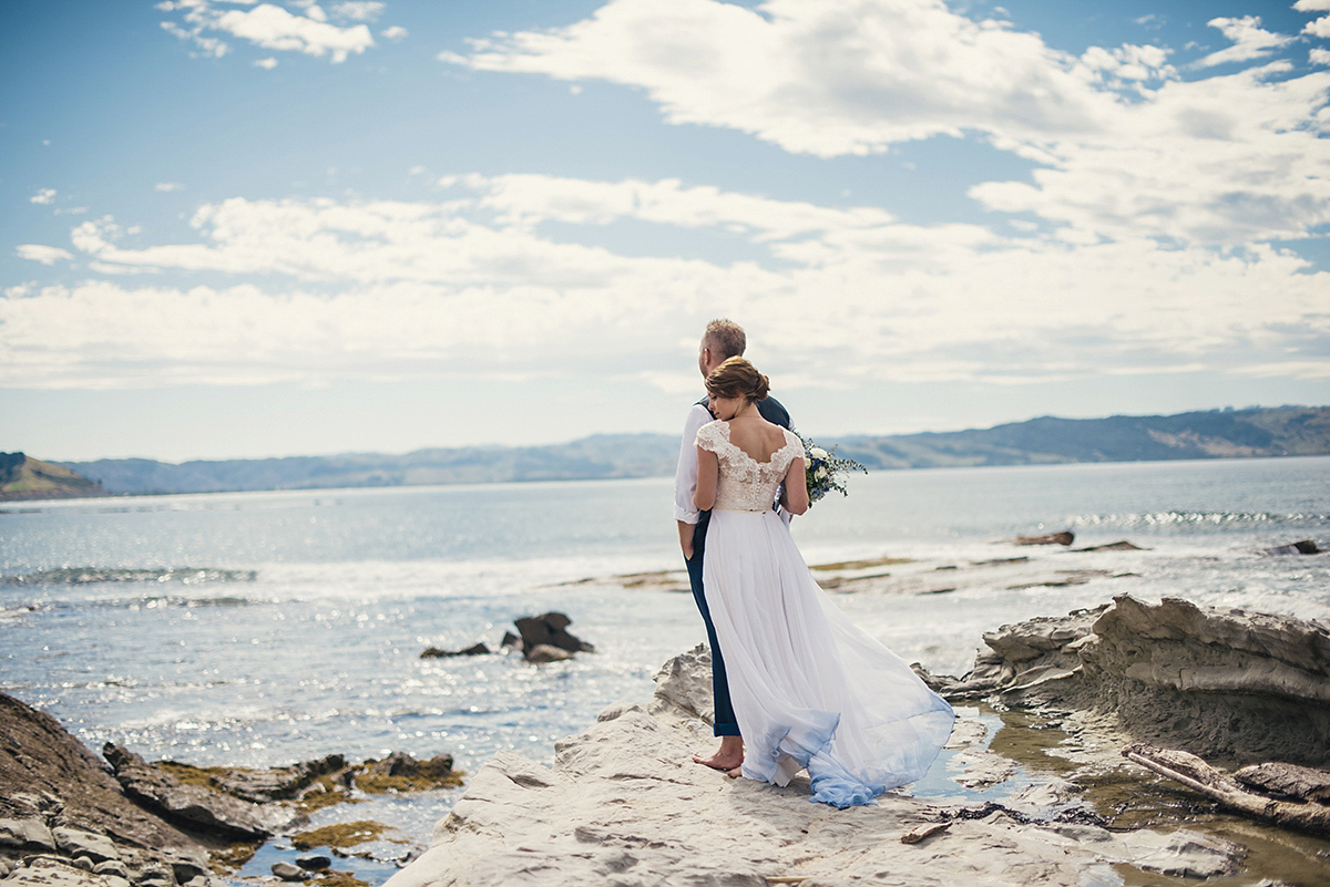 Suzy wore a stunning ombre/dip dye dress for her barefoot beach wedding in New Zealand. Photography by Meredith Lord.