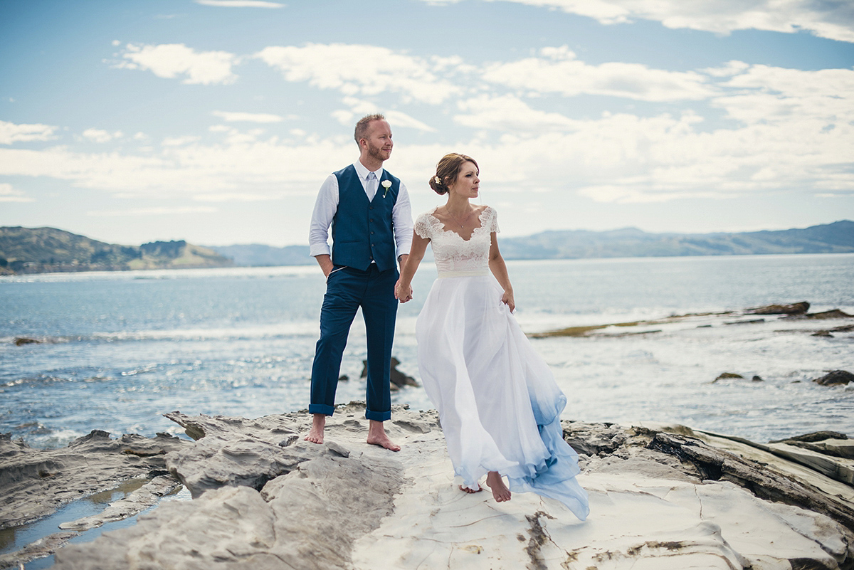 Suzy wore a stunning ombre/dip dye dress for her barefoot beach wedding in New Zealand. Photography by Meredith Lord.