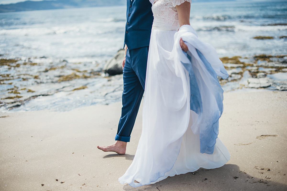 Suzy wore a stunning ombre/dip dye dress for her barefoot beach wedding in New Zealand. Photography by Meredith Lord.