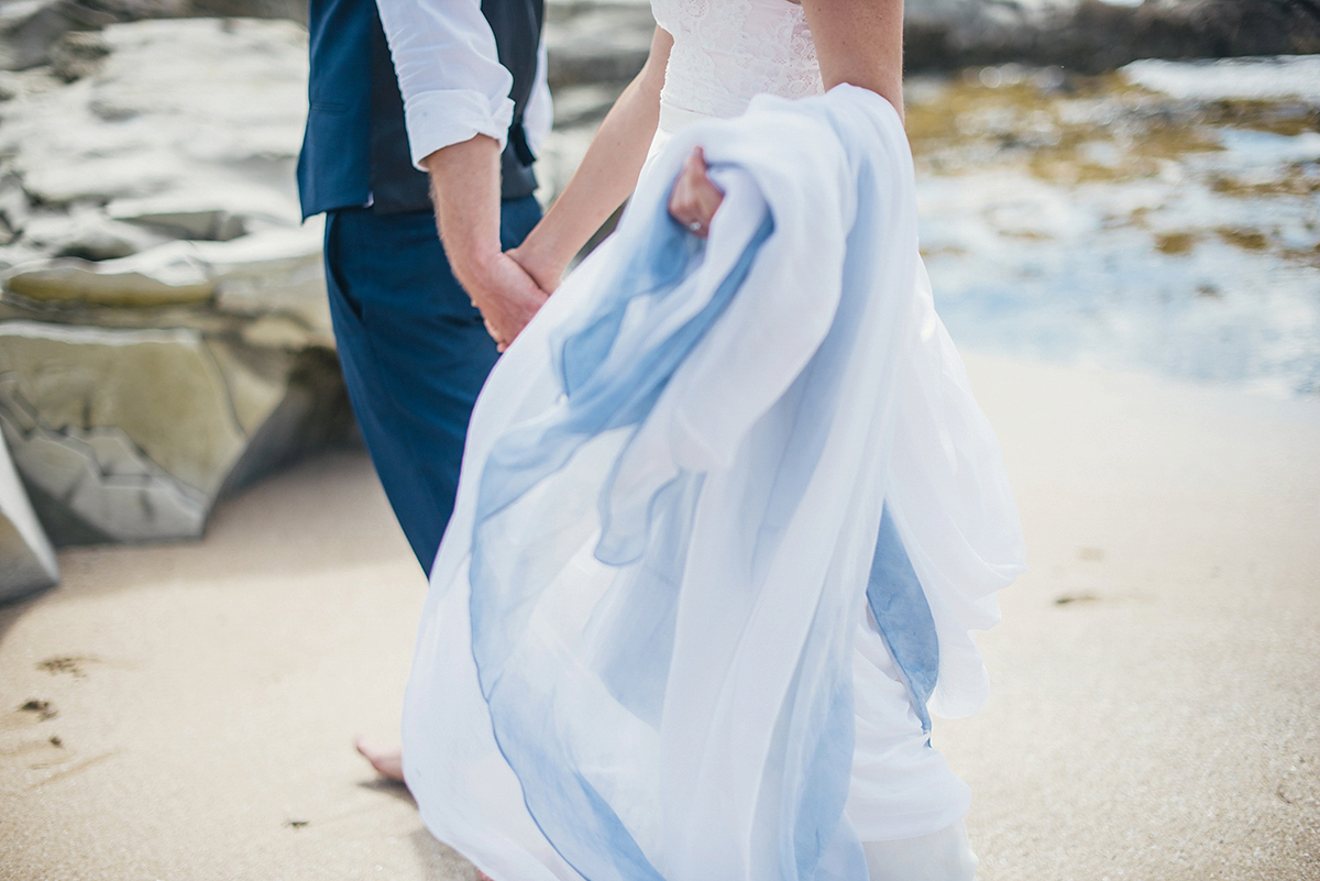 Suzy wore a stunning ombre/dip dye dress for her barefoot beach wedding in New Zealand. Photography by Meredith Lord.