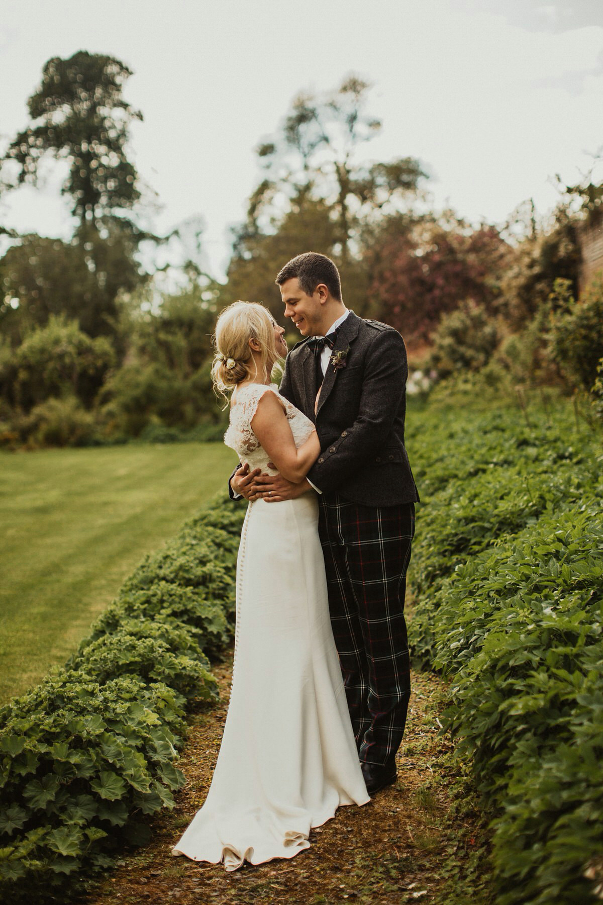 Nicola wears a Stewart Parvin gown for her elegant and romantic 'joining of the clans' inspired Scottish wedding. Photography by The Curries.