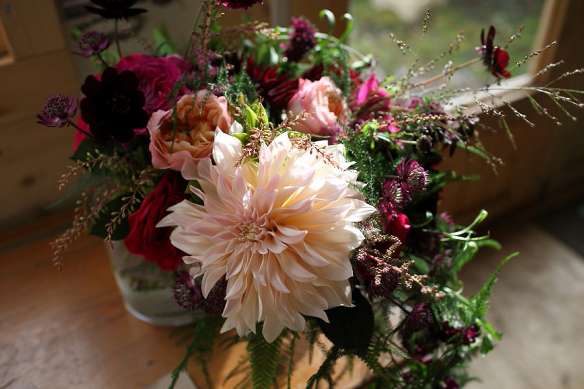 Florist Sam of Violets & Velvet wore a sequin dress by 'Somerset' by Alice Temperley for her colourful and flower-filled village hall wedding. Photography by Rebecca Prigmore.