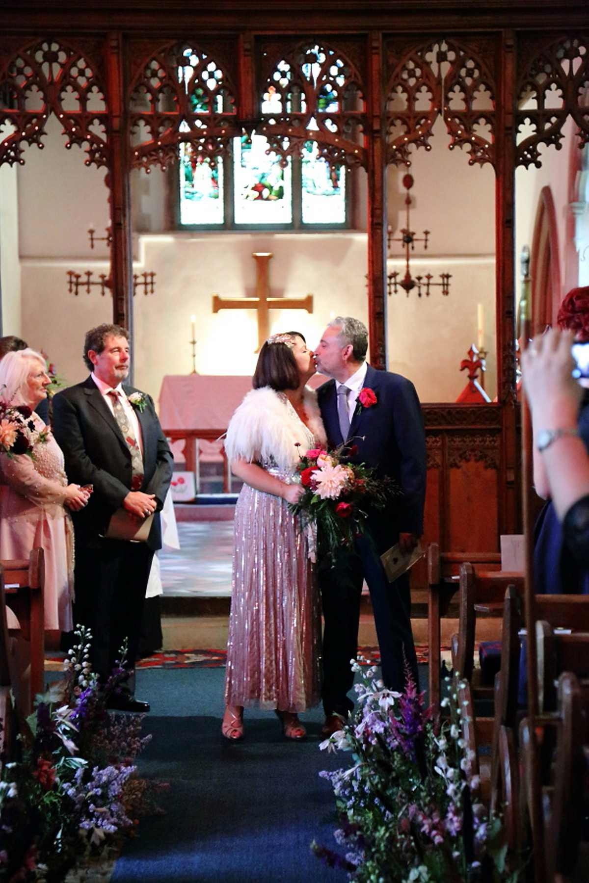 Florist Sam of Violets & Velvet wore a sequin dress by 'Somerset' by Alice Temperley for her colourful and flower-filled village hall wedding. Photography by Rebecca Prigmore.