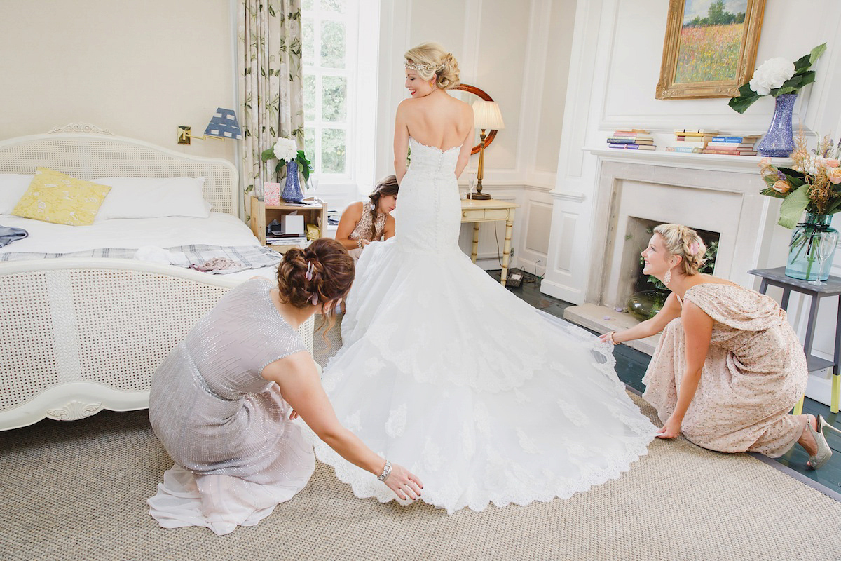 Victoria wears a Pronovias gown with a cathedral length veil for her relaxed, fun and colourful English country garden wedding in the Cotswolds. Photography by Sarah Ann Wright.