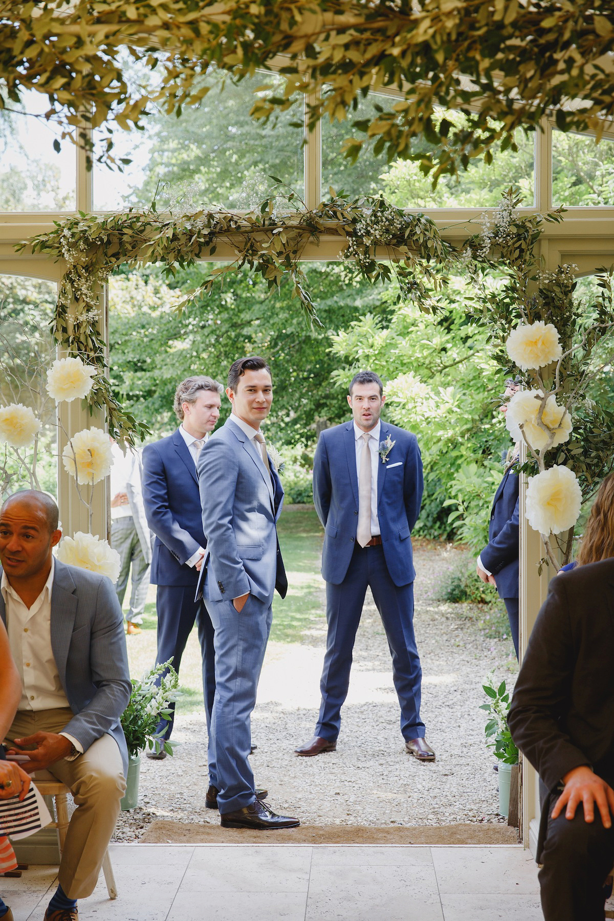 Victoria wears a Pronovias gown with a cathedral length veil for her relaxed, fun and colourful English country garden wedding in the Cotswolds. Photography by Sarah Ann Wright.