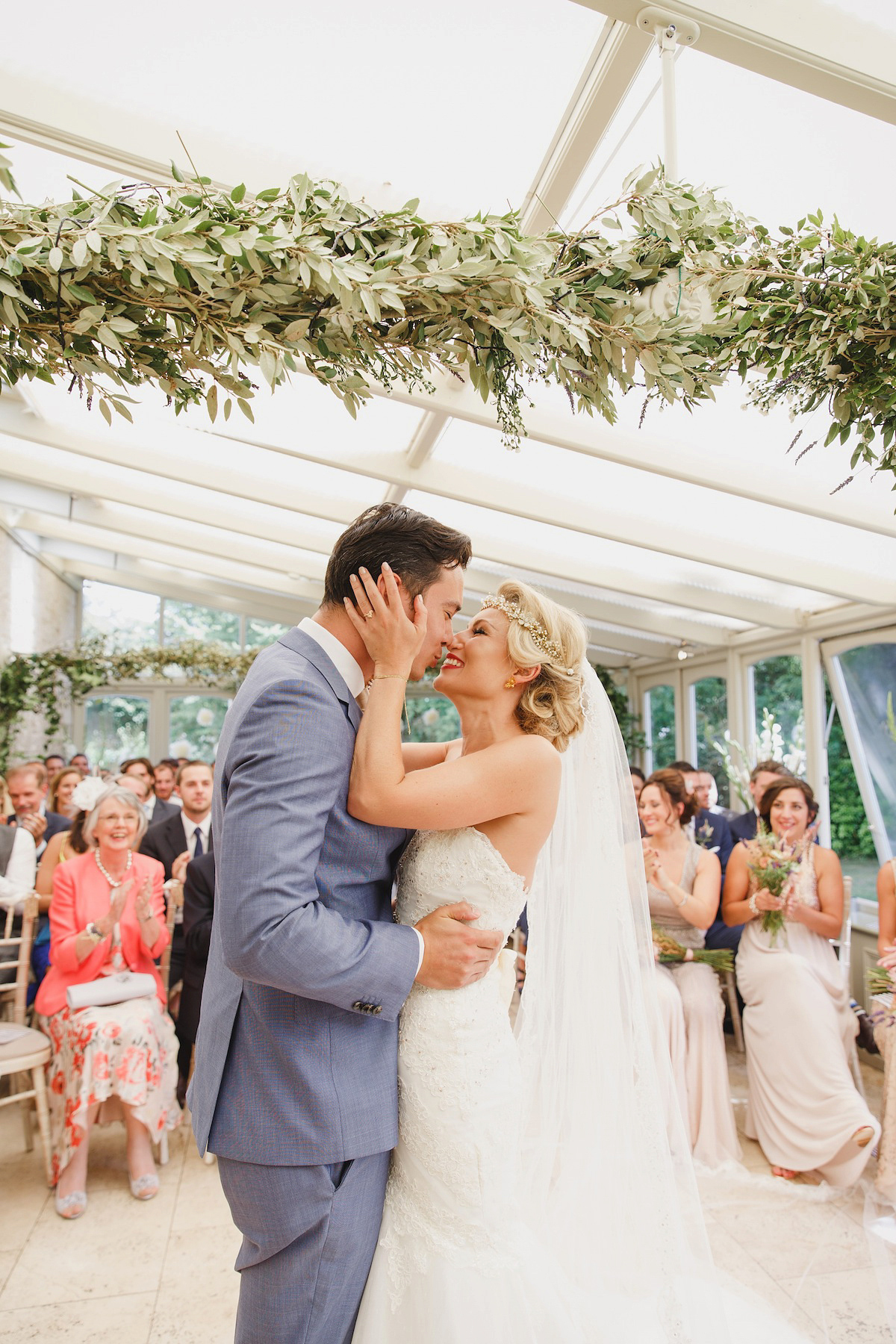 Victoria wears a Pronovias gown with a cathedral length veil for her relaxed, fun and colourful English country garden wedding in the Cotswolds. Photography by Sarah Ann Wright.