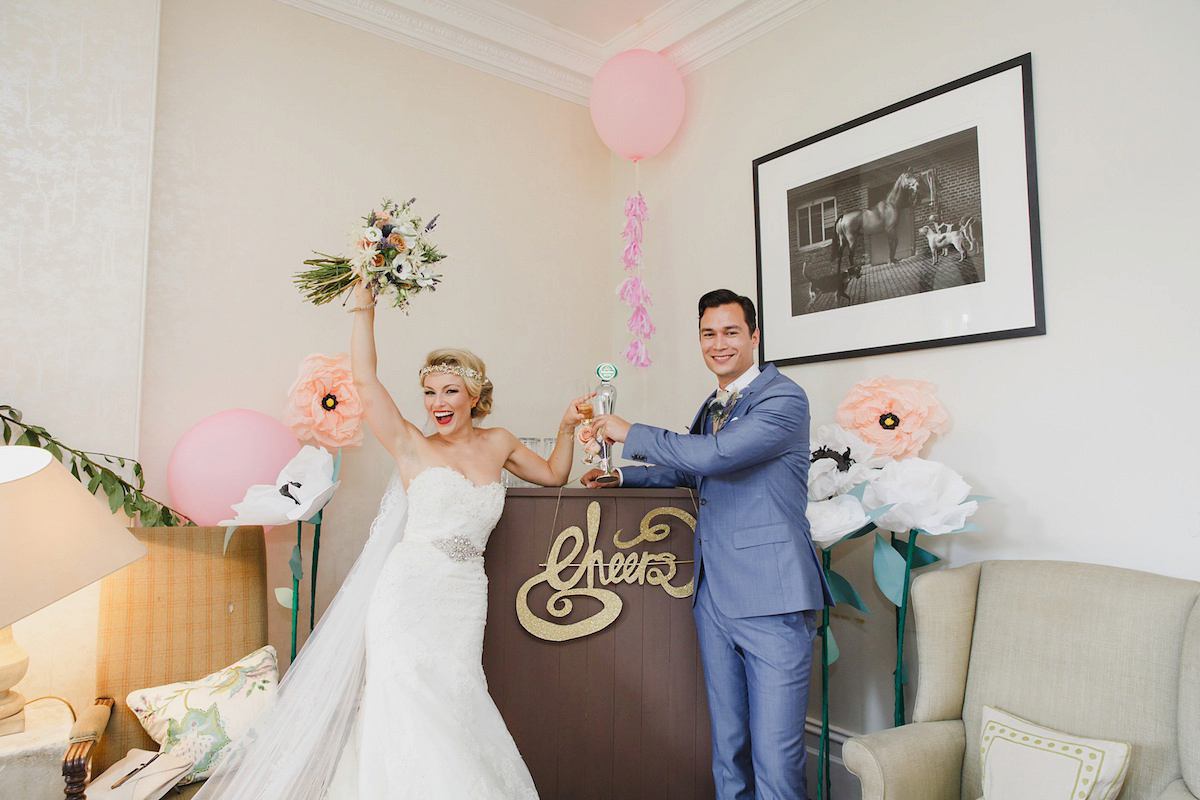 Victoria wears a Pronovias gown with a cathedral length veil for her relaxed, fun and colourful English country garden wedding in the Cotswolds. Photography by Sarah Ann Wright.