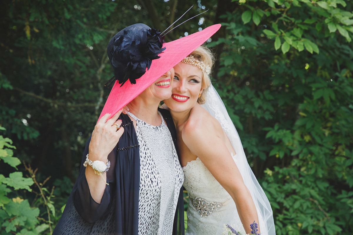 Victoria wears a Pronovias gown with a cathedral length veil for her relaxed, fun and colourful English country garden wedding in the Cotswolds. Photography by Sarah Ann Wright.