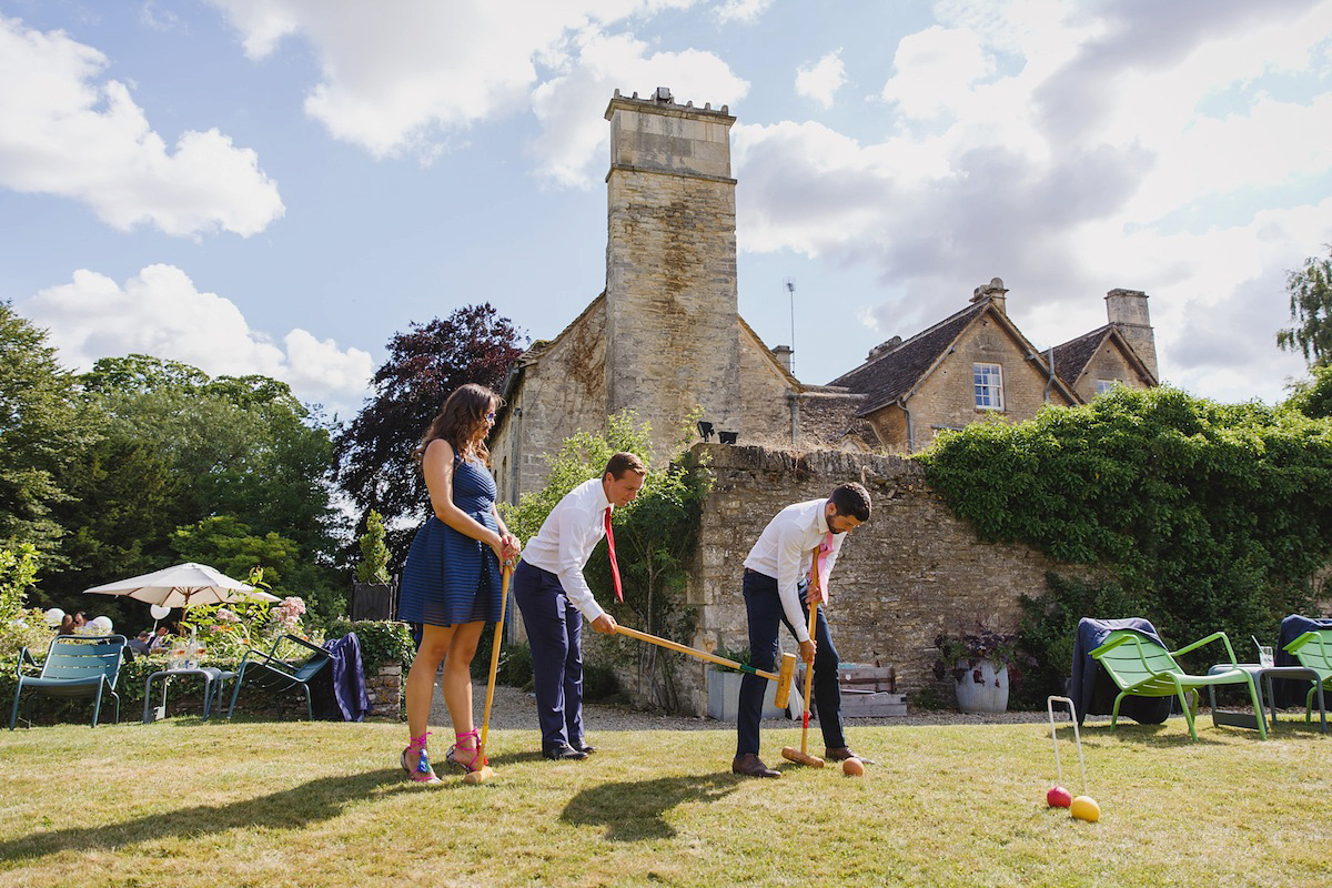 Victoria wears a Pronovias gown with a cathedral length veil for her relaxed, fun and colourful English country garden wedding in the Cotswolds. Photography by Sarah Ann Wright.