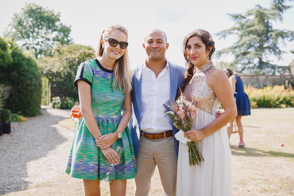 Victoria wears a Pronovias gown with a cathedral length veil for her relaxed, fun and colourful English country garden wedding in the Cotswolds. Photography by Sarah Ann Wright.