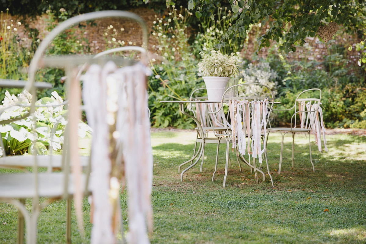 Victoria wears a Pronovias gown with a cathedral length veil for her relaxed, fun and colourful English country garden wedding in the Cotswolds. Photography by Sarah Ann Wright.