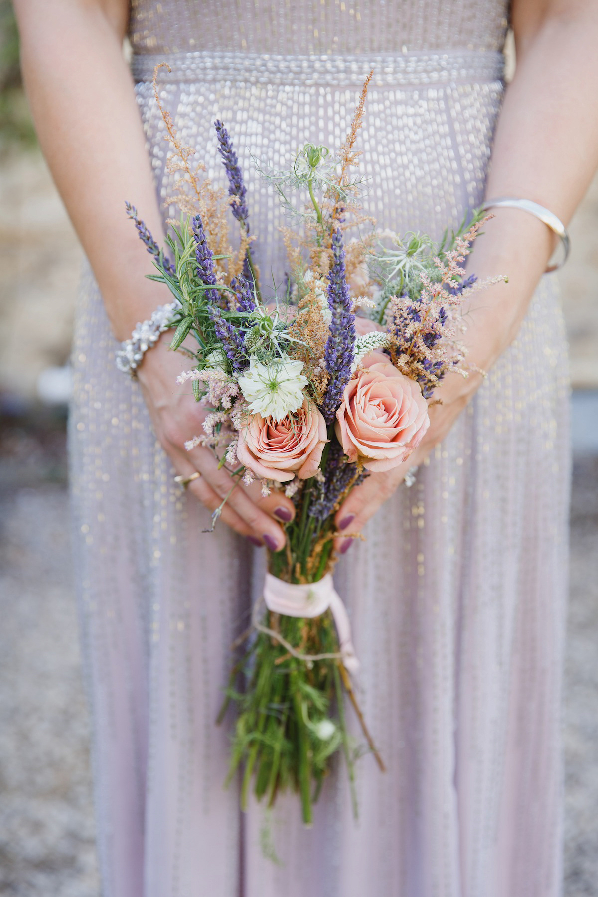 Victoria wears a Pronovias gown with a cathedral length veil for her relaxed, fun and colourful English country garden wedding in the Cotswolds. Photography by Sarah Ann Wright.