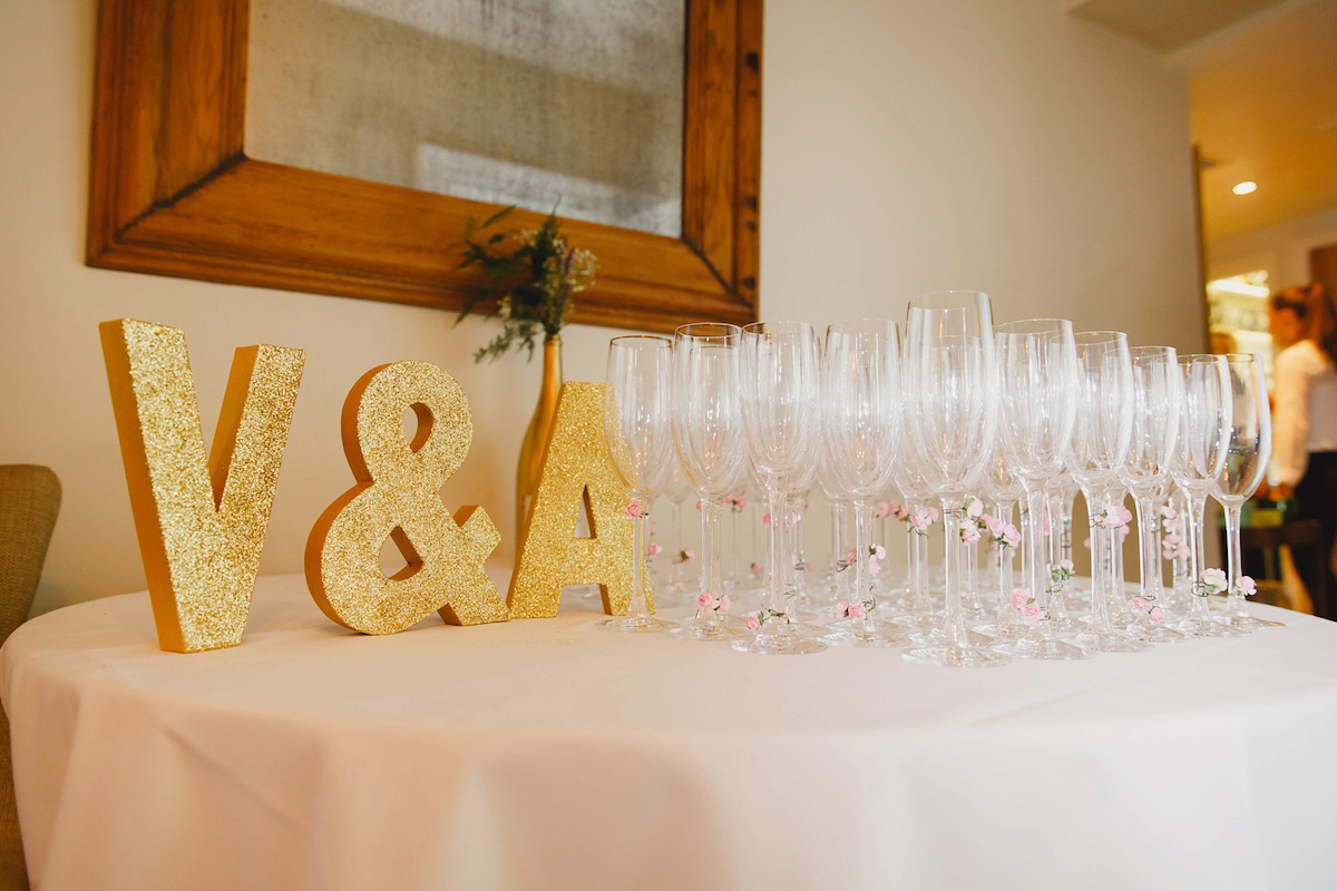 Victoria wears a Pronovias gown with a cathedral length veil for her relaxed, fun and colourful English country garden wedding in the Cotswolds. Photography by Sarah Ann Wright.