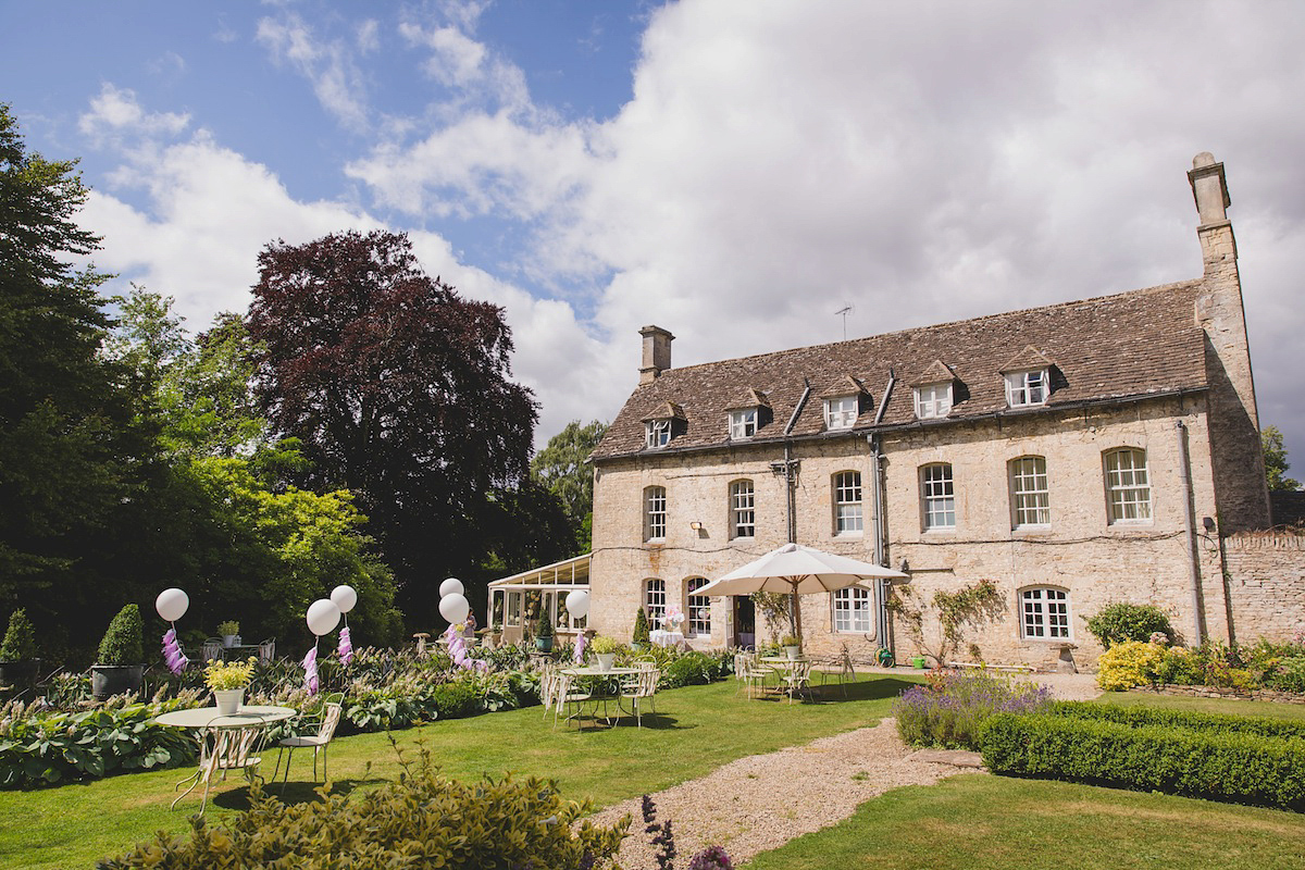 Victoria wears a Pronovias gown with a cathedral length veil for her relaxed, fun and colourful English country garden wedding in the Cotswolds. Photography by Sarah Ann Wright.