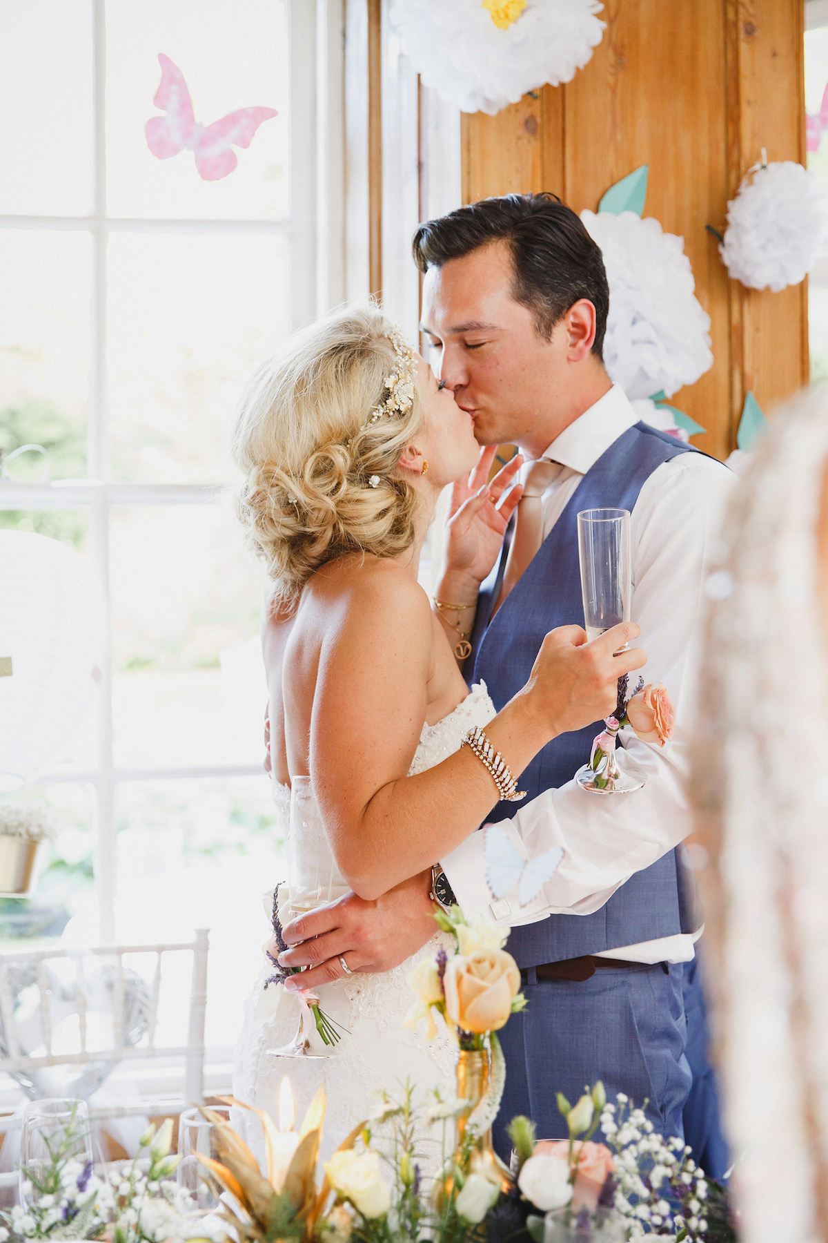 Victoria wears a Pronovias gown with a cathedral length veil for her relaxed, fun and colourful English country garden wedding in the Cotswolds. Photography by Sarah Ann Wright.