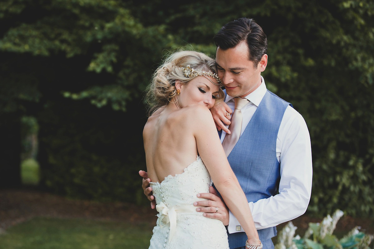 Victoria wears a Pronovias gown with a cathedral length veil for her relaxed, fun and colourful English country garden wedding in the Cotswolds. Photography by Sarah Ann Wright.