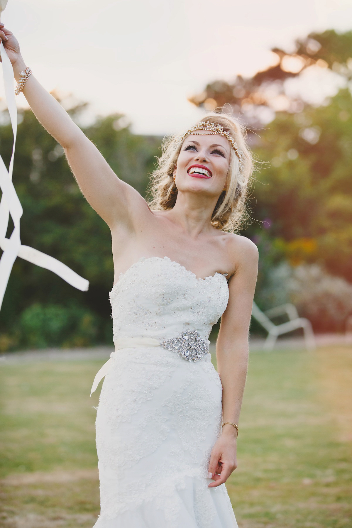 Victoria wears a Pronovias gown with a cathedral length veil for her relaxed, fun and colourful English country garden wedding in the Cotswolds. Photography by Sarah Ann Wright.