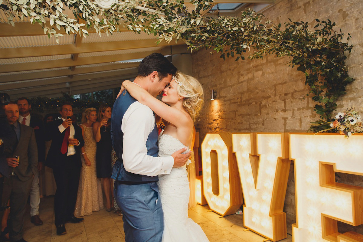 Victoria wears a Pronovias gown with a cathedral length veil for her relaxed, fun and colourful English country garden wedding in the Cotswolds. Photography by Sarah Ann Wright.