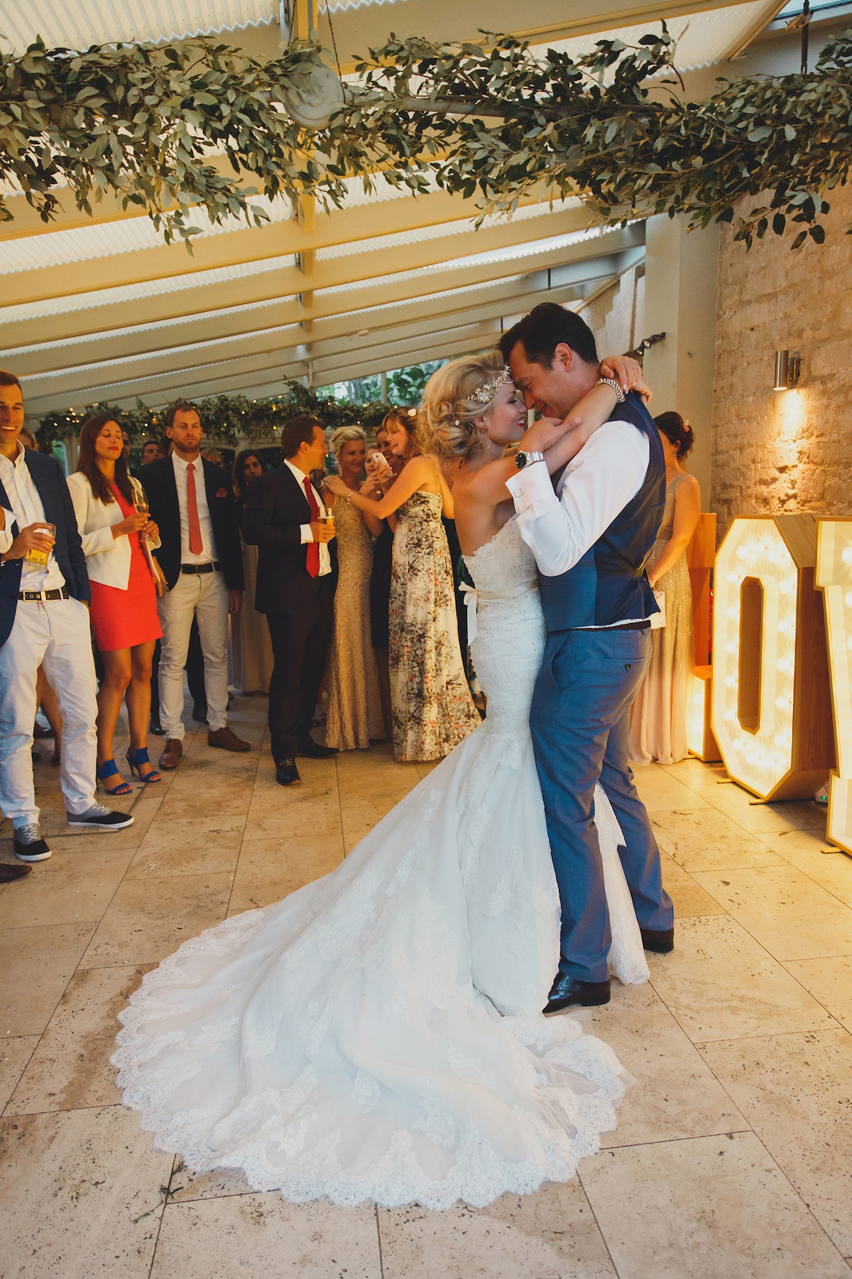 Victoria wears a Pronovias gown with a cathedral length veil for her relaxed, fun and colourful English country garden wedding in the Cotswolds. Photography by Sarah Ann Wright.