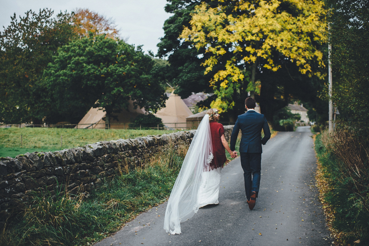 Lucy wore a 1920s inspired drop waist gown by Charlie Brear for her magical Autumn Papakata tipi wedding at Middlesmoor in Yorkshire. Silversixpence Films + Flawless Photography.