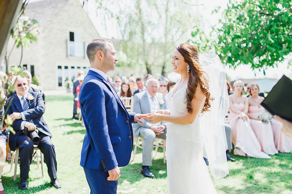 Stephanie wore a backless lace dress for her outdoor Spring wedding held at Hyde House country house hotel. Images by White Stag Photography.