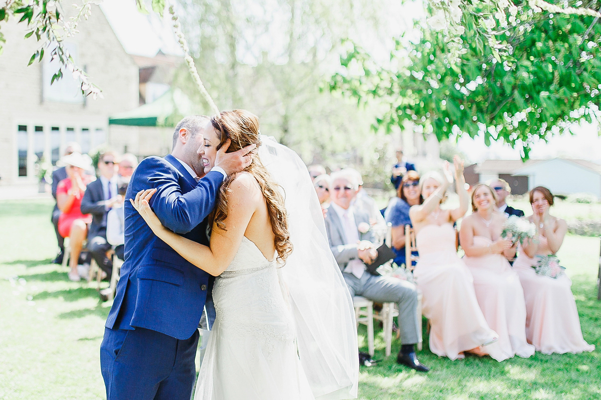 Stephanie wore a backless lace dress for her outdoor Spring wedding held at Hyde House country house hotel. Images by White Stag Photography.