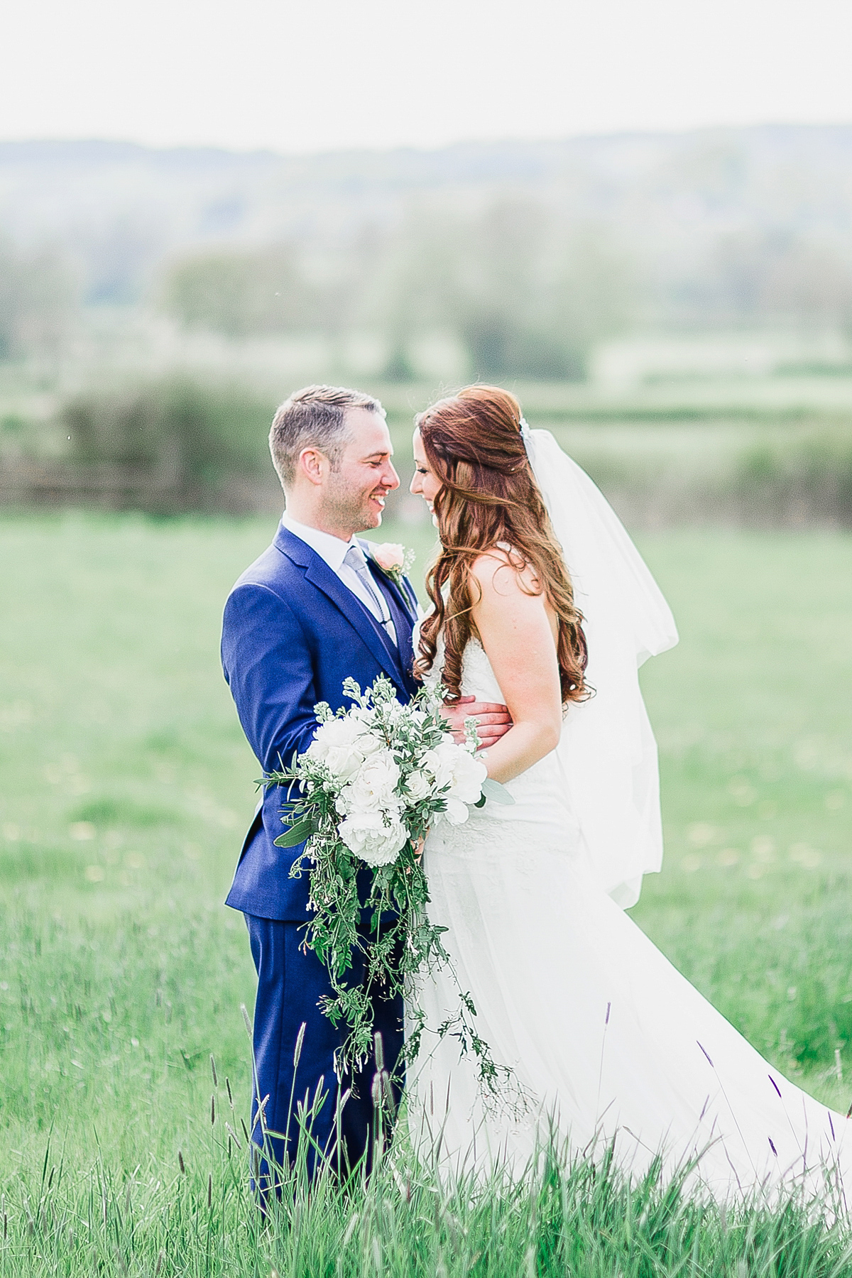 Stephanie wore a backless lace dress for her outdoor Spring wedding held at Hyde House country house hotel. Images by White Stag Photography.