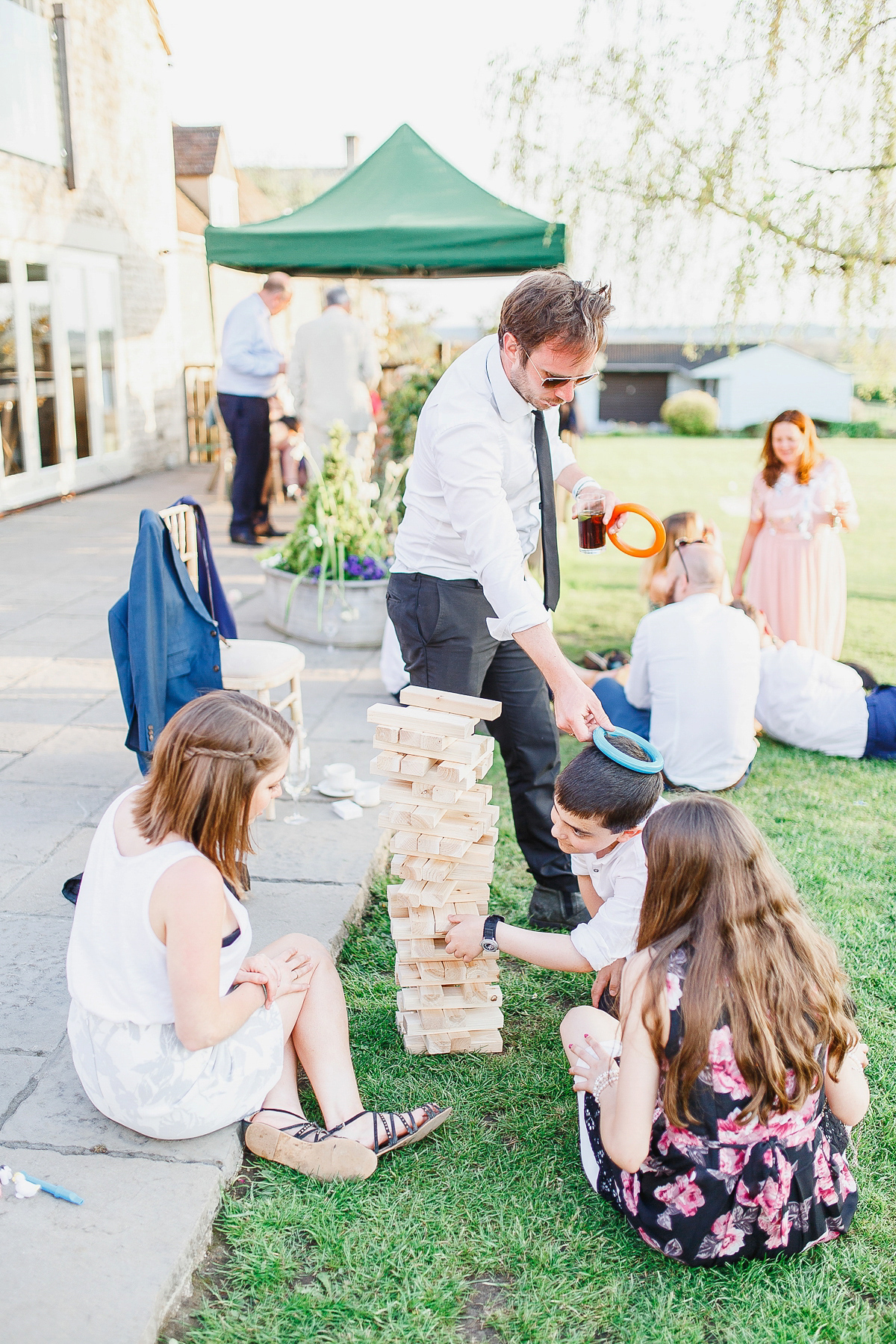 Stephanie wore a backless lace dress for her outdoor Spring wedding held at Hyde House country house hotel. Images by White Stag Photography.