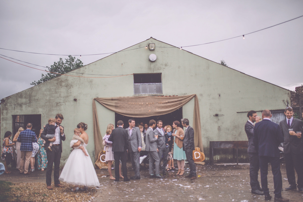 Georgie wore a 1950's inspired Essense of Australia gown for her rustic and rural Somerset barn wedding. Photography by Naomi Jane.