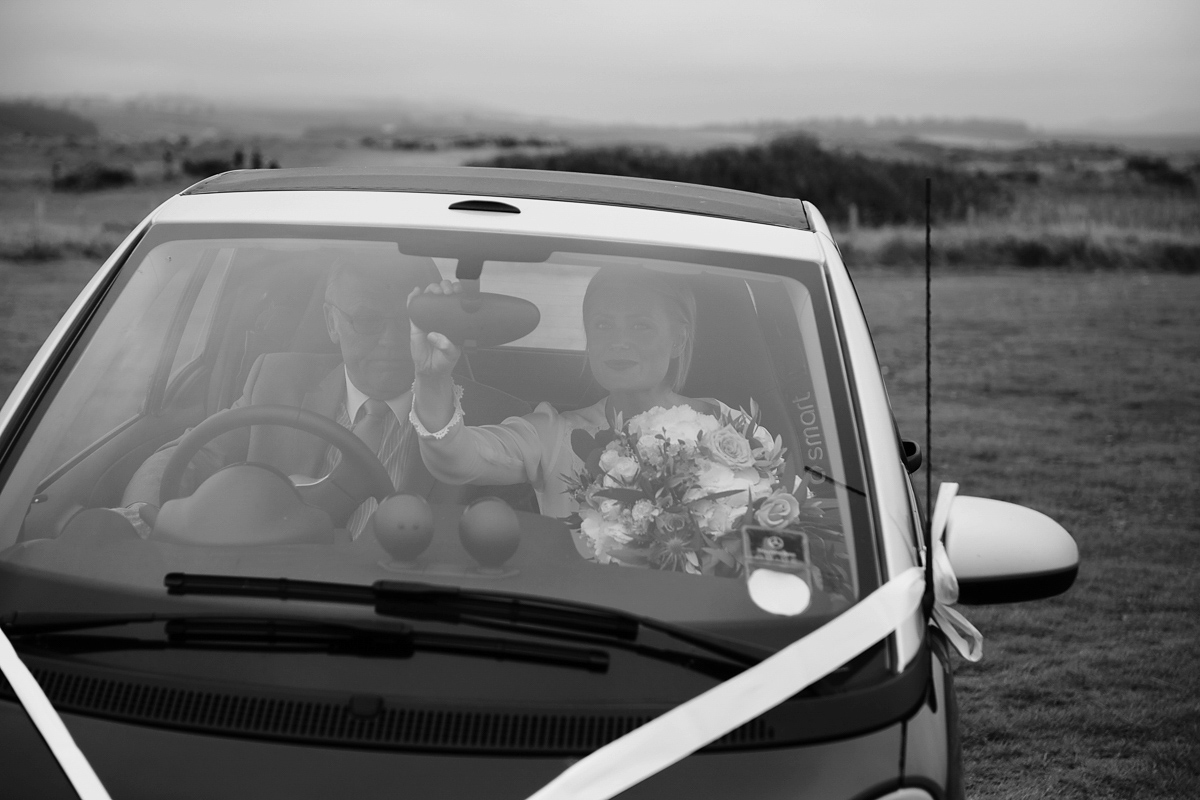 Laura wears a 1970's inspired Stone Cold Fox wedding dress for her laid back and organic beach wedding in Scotland. Photography by Tino and Pip.