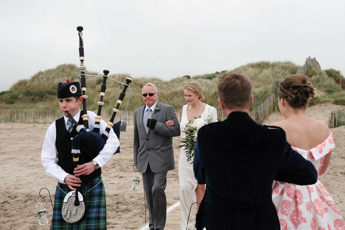 Laura wears a 1970's inspired Stone Cold Fox wedding dress for her laid back and organic beach wedding in Scotland. Photography by Tino and Pip.