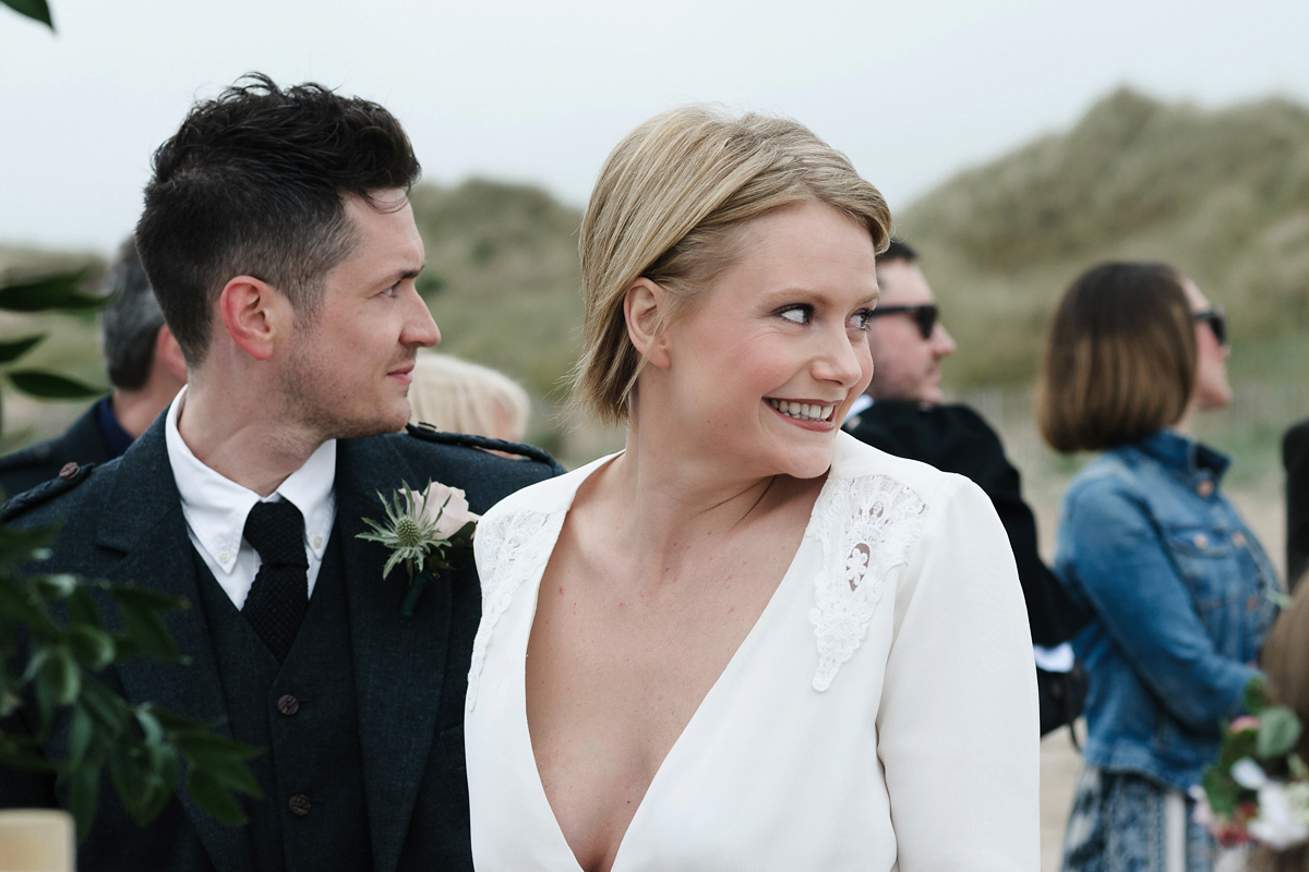 Laura wears a 1970's inspired Stone Cold Fox wedding dress for her laid back and organic beach wedding in Scotland. Photography by Tino and Pip.