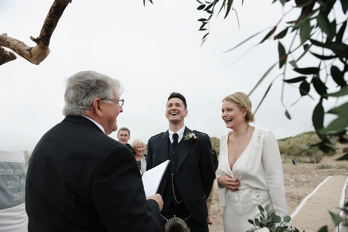 Laura wears a 1970's inspired Stone Cold Fox wedding dress for her laid back and organic beach wedding in Scotland. Photography by Tino and Pip.