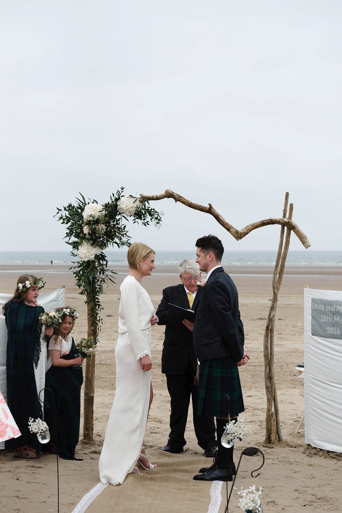 Laura wears a 1970's inspired Stone Cold Fox wedding dress for her laid back and organic beach wedding in Scotland. Photography by Tino and Pip.